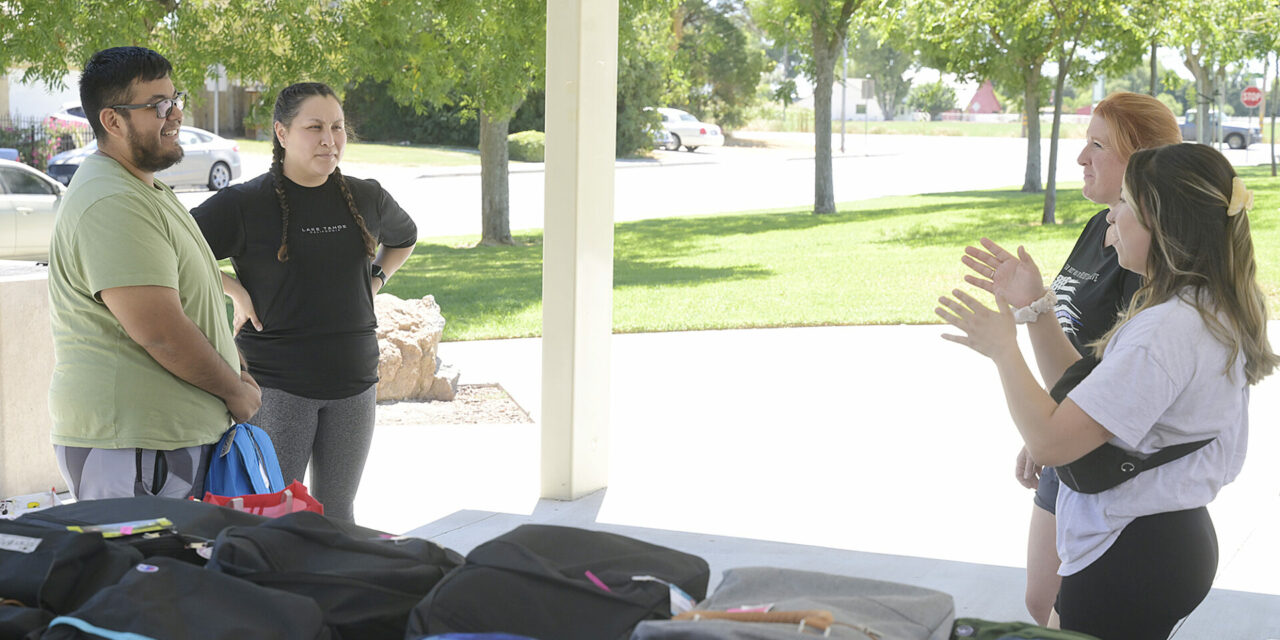 Book club collects, distributes school supplies  