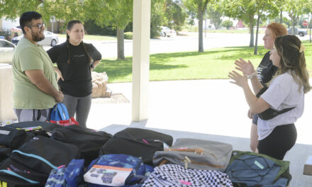 Book club collects, distributes school supplies  