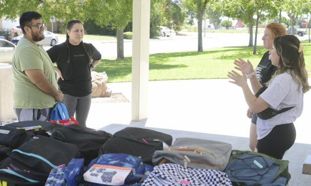 Book club collects, distributes school supplies  